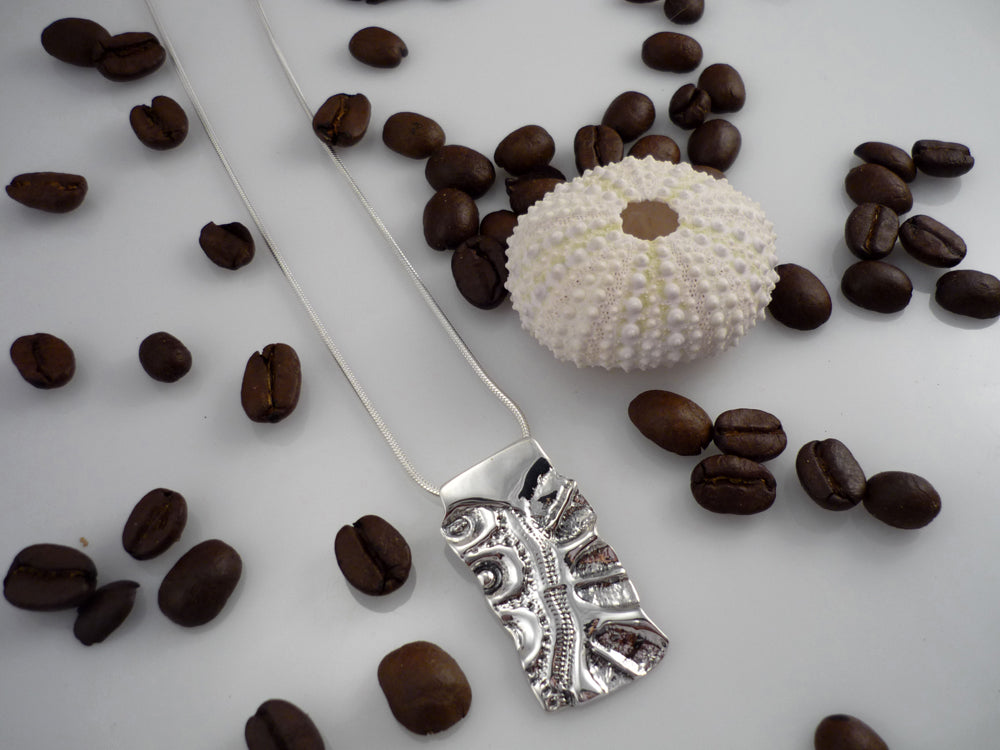 LAND AND SEA LARGE, sterling silver pendant with a sea urchin shell and coffee bean imprint!