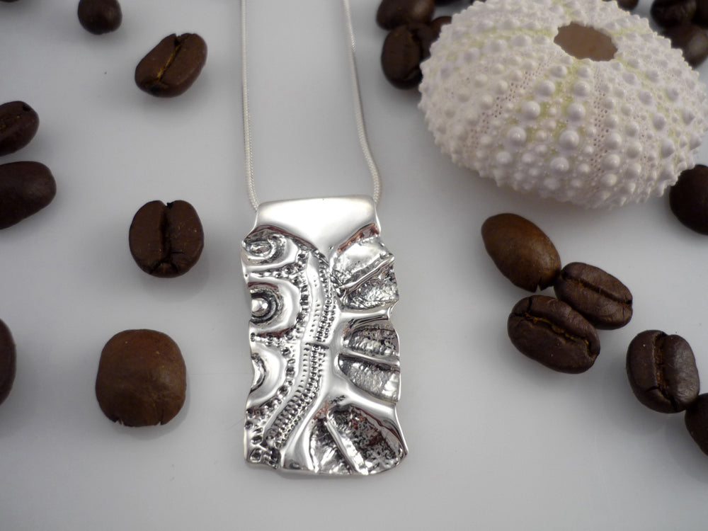 LAND AND SEA LARGE, sterling silver pendant with a sea urchin shell and coffee bean imprint!