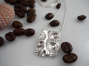 LAND AND SEA MEDIUM, sterling silver pendant with a sea urchin shell and coffee bean imprint!